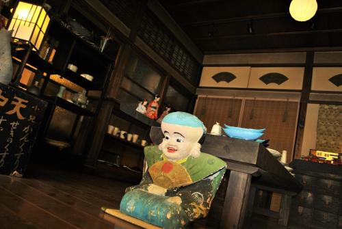 a statue of a person sitting on a table at Hotel Kazahaya in Hita