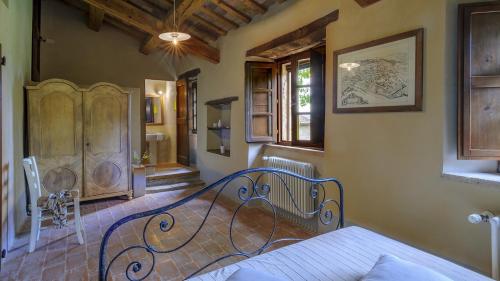 a bedroom with a wrought iron bed in a room at Checello 12 by Marche Holiday Villas in Cagli