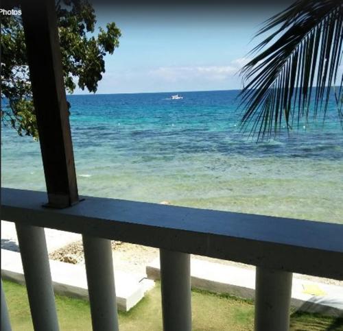 a view of the ocean from a balcony at Anton's Beach Resort in Oslob