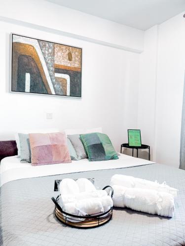 a bedroom with a bed with two towels on it at Ikarus in Limassol