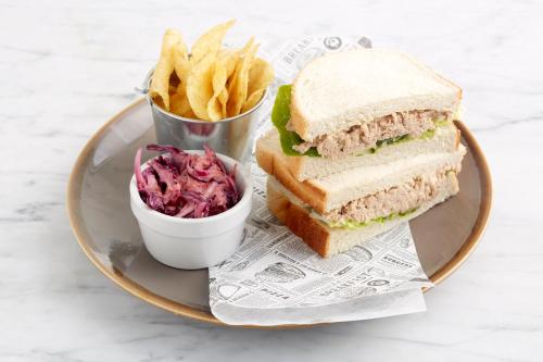 a sandwich on a plate with a side of fries at Holiday Inn Ipswich by IHG in Ipswich