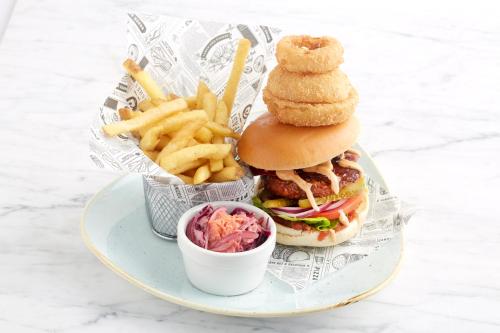 a plate with a sandwich and french fries and a cup of coleslaw at Holiday Inn Ipswich by IHG in Ipswich