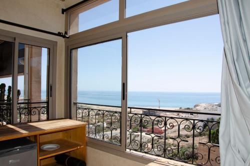 a balcony with a view of the ocean at SurfAppart Morocco in Tamraght Ouzdar