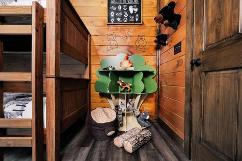 a room with a bunk bed with a green chair at Saving Grace Where the Mountains Save the Day in Pigeon Forge