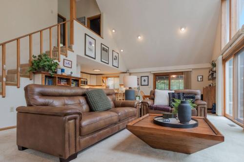a living room with a couch and a table at Fireplace Fire Pit Covered Porch & Resort Access in Hedgesville
