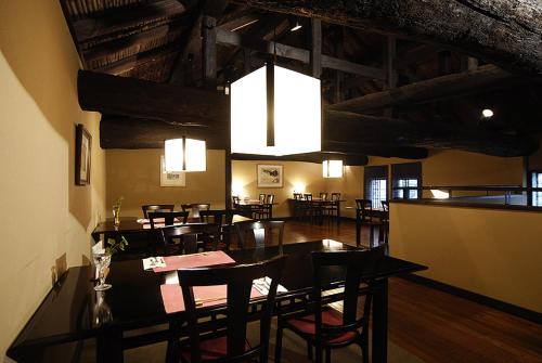 a dining room with tables and chairs and a chandelier at Hotel Kazahaya in Hita