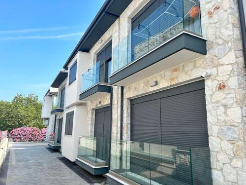 an exterior view of a building with black garage doors at MagnusLux apartment in Hanioti