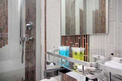 a bathroom with a shower and a sink and a mirror at 3х комнатная 2 спальни Арбат ЖК Столичный центр in Almaty