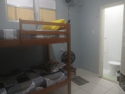 a bedroom with two bunk beds and a bathroom at Hostel Recanto dos Viajantes in Belém