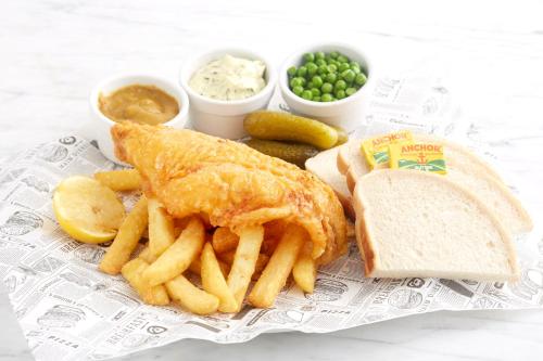 a plate of food with a fish sandwich and french fries at Holiday Inn - Leicester - Wigston by IHG in Leicester