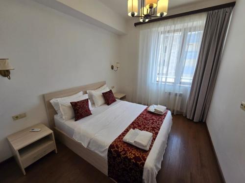 a bedroom with a large bed with a window at Ararat View Apartments in Yerevan
