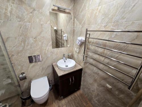 a bathroom with a toilet and a sink at Ararat View Apartments in Yerevan