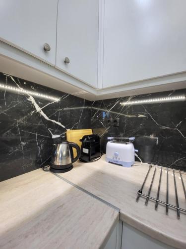 a kitchen counter with a toaster and appliances on it at Luxury apartment center of Varkiza Resort in Vari