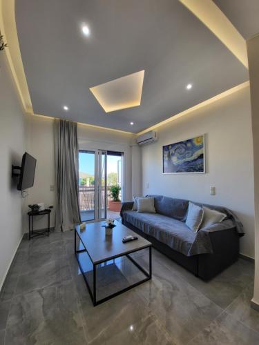 a living room with a couch and a table at Luxury apartment center of Varkiza Resort in Vari