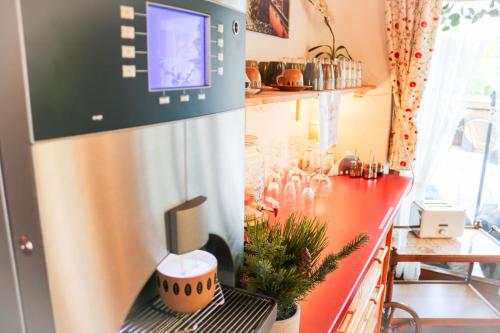 a kitchen with a red counter top and a counter top at House of Happiness by apartmentglück in Schluchsee