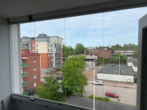 a view from a window of a parking lot at City Bloom Apartment in Kotka