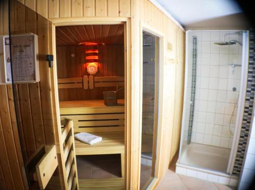 a small bathroom with a shower and a sink at House of Happiness by apartmentglück in Schluchsee