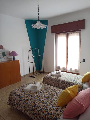 a room with two beds with towels on them at La Casa Sicula in Capri Leone