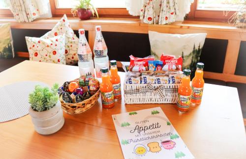 a table with bottles of soda and baskets of snacks at House of Happiness by apartmentglück in Schluchsee