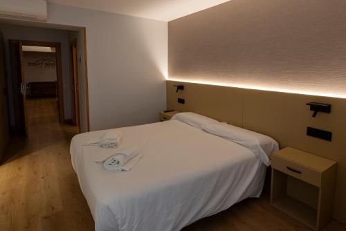 a bedroom with a white bed in a room at EightRooms La Rioja Pension in Logroño