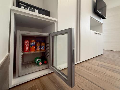 a small refrigerator with a mirror in a kitchen at A 2 passi dal centro in Matera