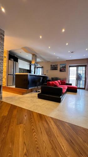 a living room with two red couches and a fireplace at Residenza fuorigrotta stadio in Naples