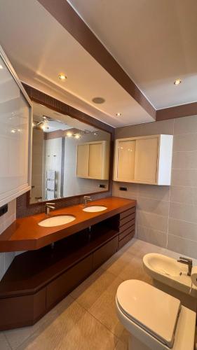 a bathroom with two sinks and a toilet at Residenza fuorigrotta stadio in Naples