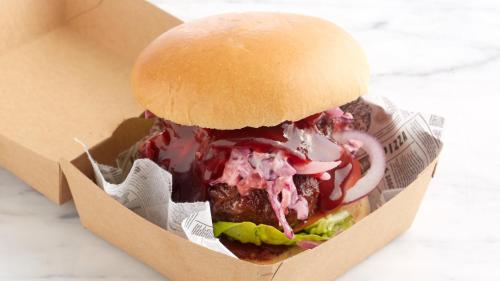 a hamburger in a box with sauce and onions at Holiday Inn Leeds Garforth by IHG in Garforth