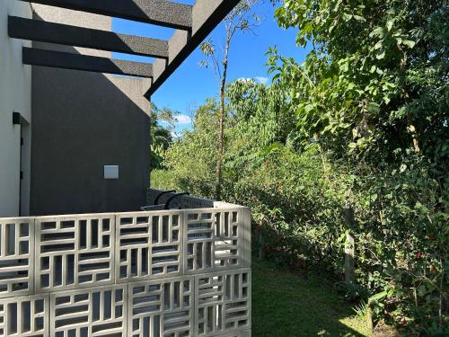 a white wicker fence next to a house at Vila do Porto Pousada in Morretes