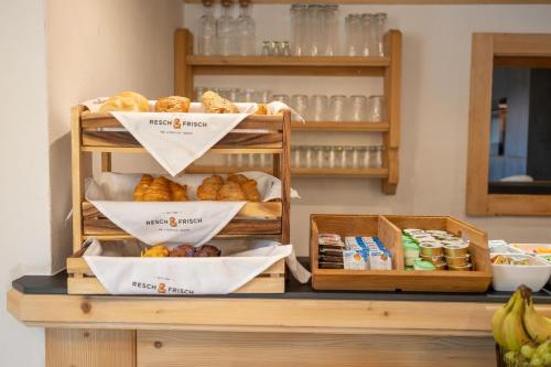 a display of bread and pastries on a counter at Hofers Herzstück in Saalbach Hinterglemm