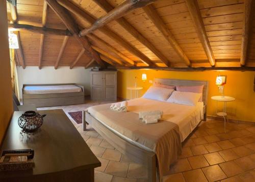 a bedroom with a large bed with a wooden ceiling at Zest House in Santa Venerina