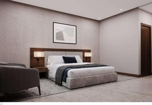 a bedroom with a king sized bed and a chair at مرسال بارك in Riyadh