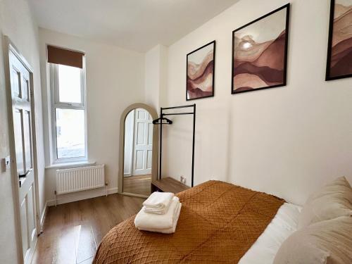 a bedroom with a bed and a mirror on the wall at Chic & Modern 2BR Apartment - Luxury Manchester Retreat in Manchester