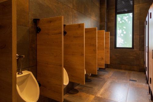 a row of urinals in a public restroom at Casa Noral Hotel in Copacabana
