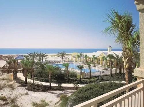 a view of a resort with a pool and palm trees at Le Reve Chamant- Martinique Villa in Gulf Highlands