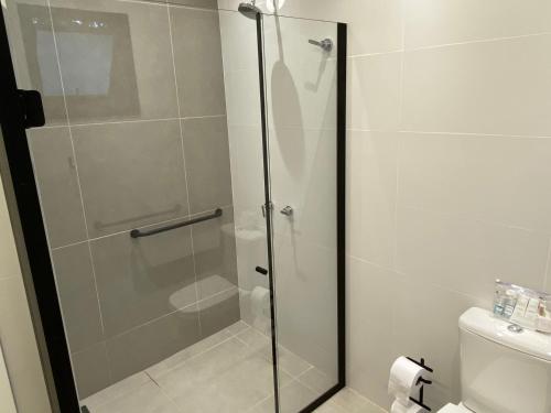 a shower with a glass door in a bathroom at Vila do Porto Pousada in Morretes