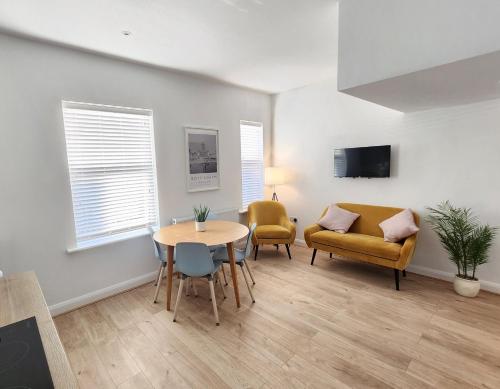 a living room with a couch and a table and chairs at Cozy & Bright 2BR in Long Eaton in Long Eaton