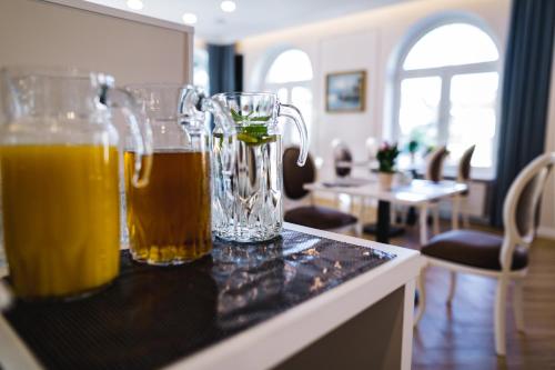 two glasses of beer sitting on top of a counter at Moris Beach Hotel in Gdańsk
