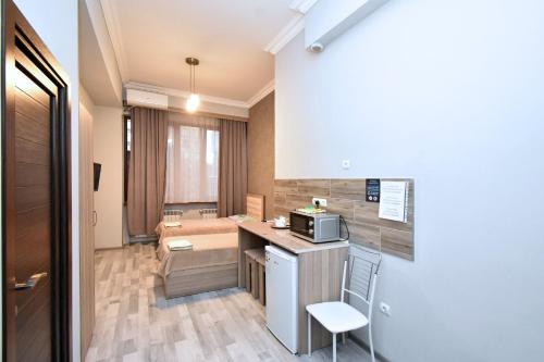 a small kitchen with a counter and a microwave at Komitas Residence in Yerevan
