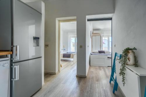 a kitchen with a refrigerator and a bedroom at VILA SENTIO MARE-Apartments Livaić Željko in Pirovac