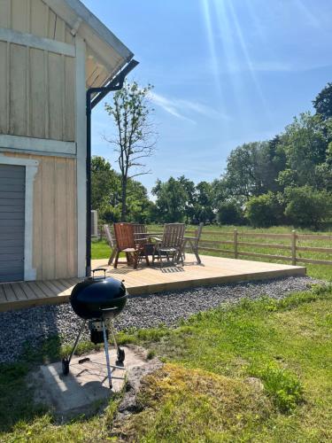 a grill in front of a building with a table and chairs at Brygghuset in Linköping