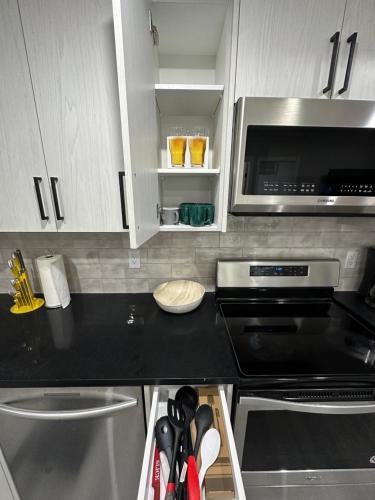 a kitchen with a black counter top and a microwave at Beautiful 2 bedroom 2 bath in NW Calgary in Calgary