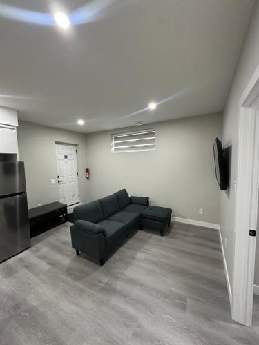a living room with a couch and a tv at Beautiful 2 bedroom 2 bath in NW Calgary in Calgary