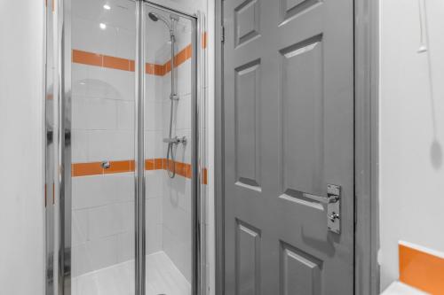a shower stall with a door in a bathroom at 7 Bed House Pitchford Road in Earlham