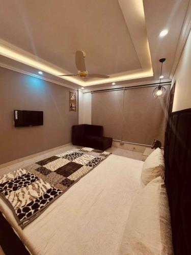 a large bed in a room with a ceiling at Cozy Nook Apartments in Lahore