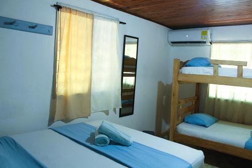 a bedroom with two bunk beds and a window at Casa Bambudas in Rincón
