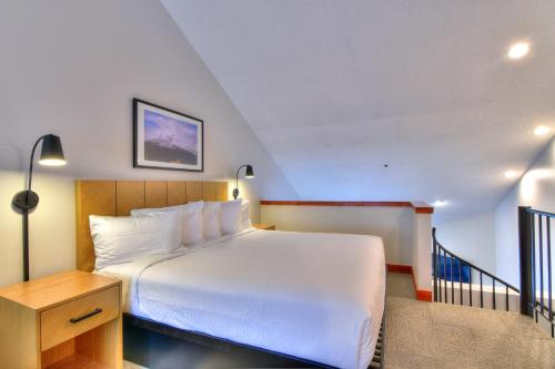 a hotel room with a bed and a staircase at Wedgewood Lodge in Breckenridge