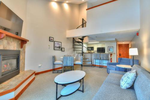 a living room with a couch and a fireplace at Wedgewood Lodge in Breckenridge