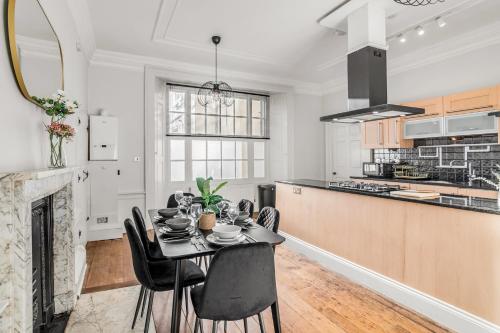a kitchen and dining room with a table and chairs at Beautiful 2 bed apartment in the heart of the city in Norwich