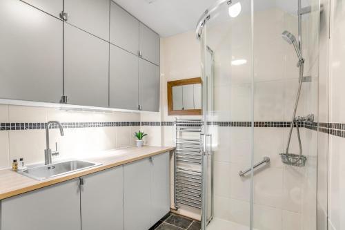 a bathroom with a shower and a sink at Beautiful 2 bed apartment in the heart of the city in Norwich
